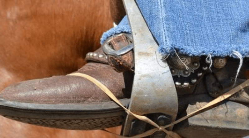 A Western rider's foot rubber banded to the stirrup.